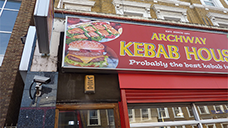Photograph showing the shop signage prior to the refurbishment by Lyndon Goode Architects